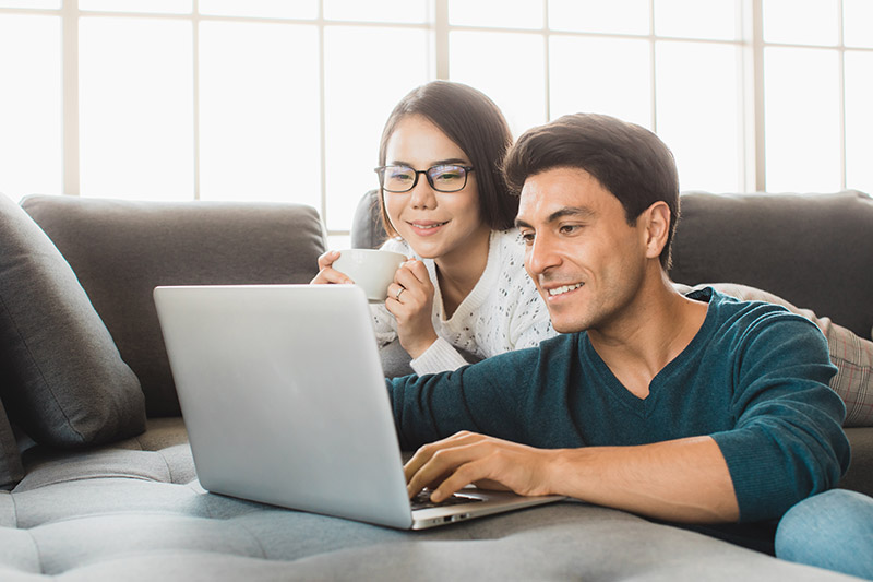 Couple looking at computer - house loan down payment options